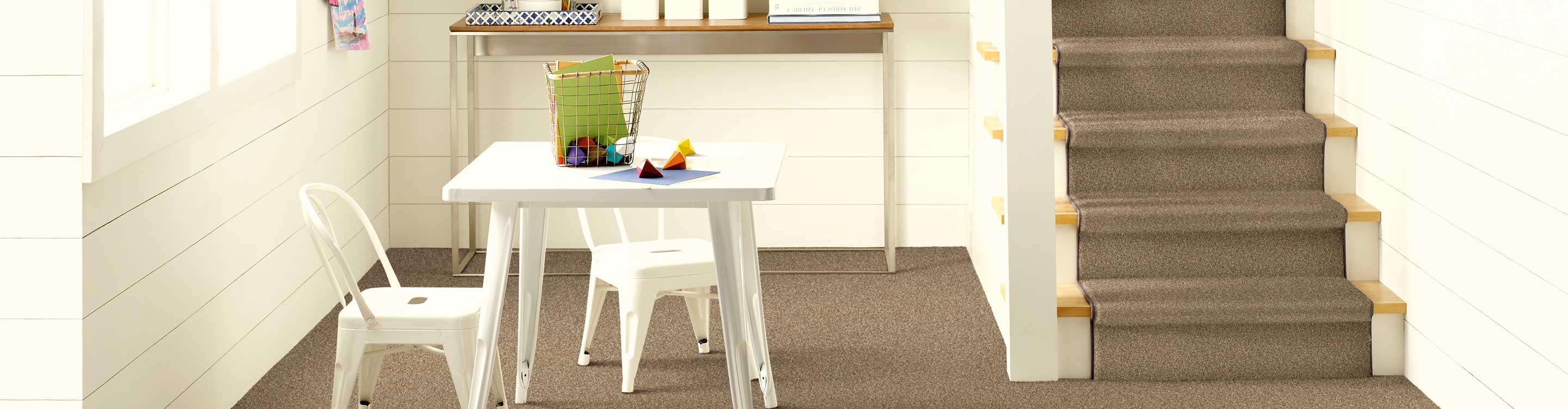 brown stair runner on staircase and carpet in living area with kids toys