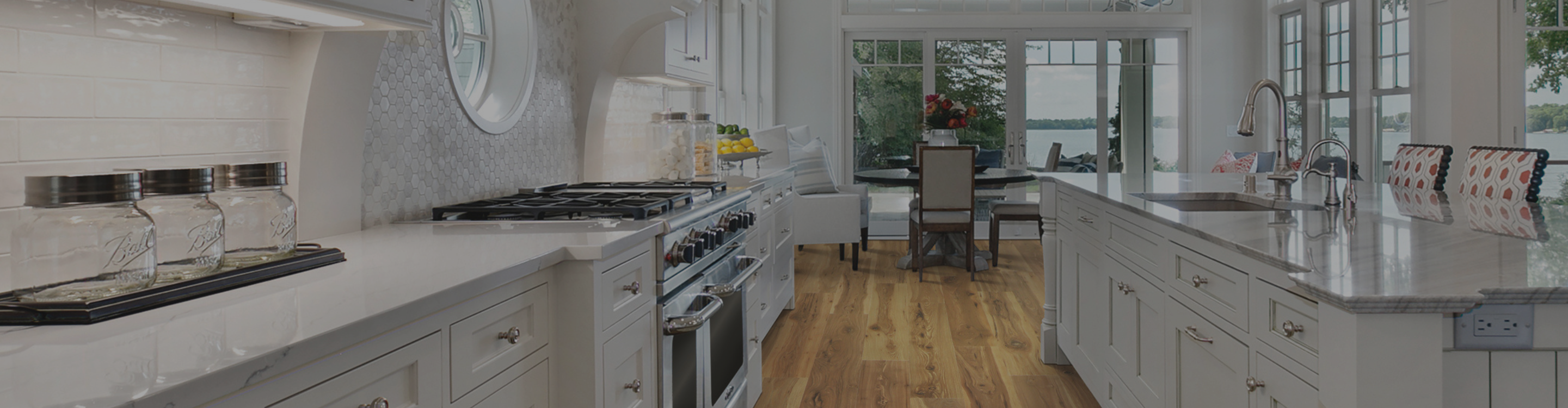Laminate flooring in a kitchen with wood-look laminate and white cabinetry