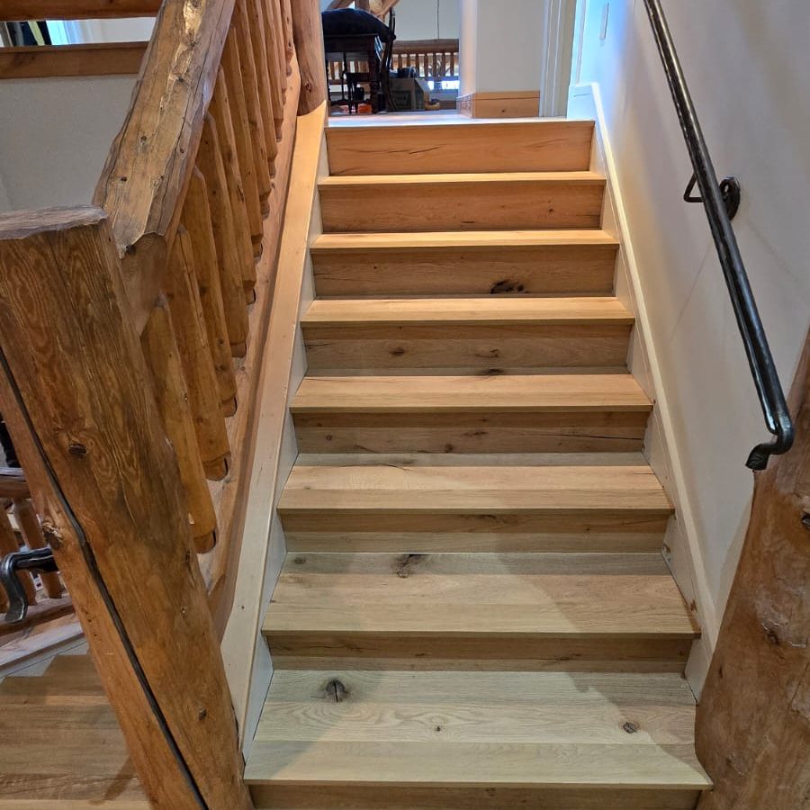 Stairs with complete hardwood flooring from Ruggs Benedict Carpet One.