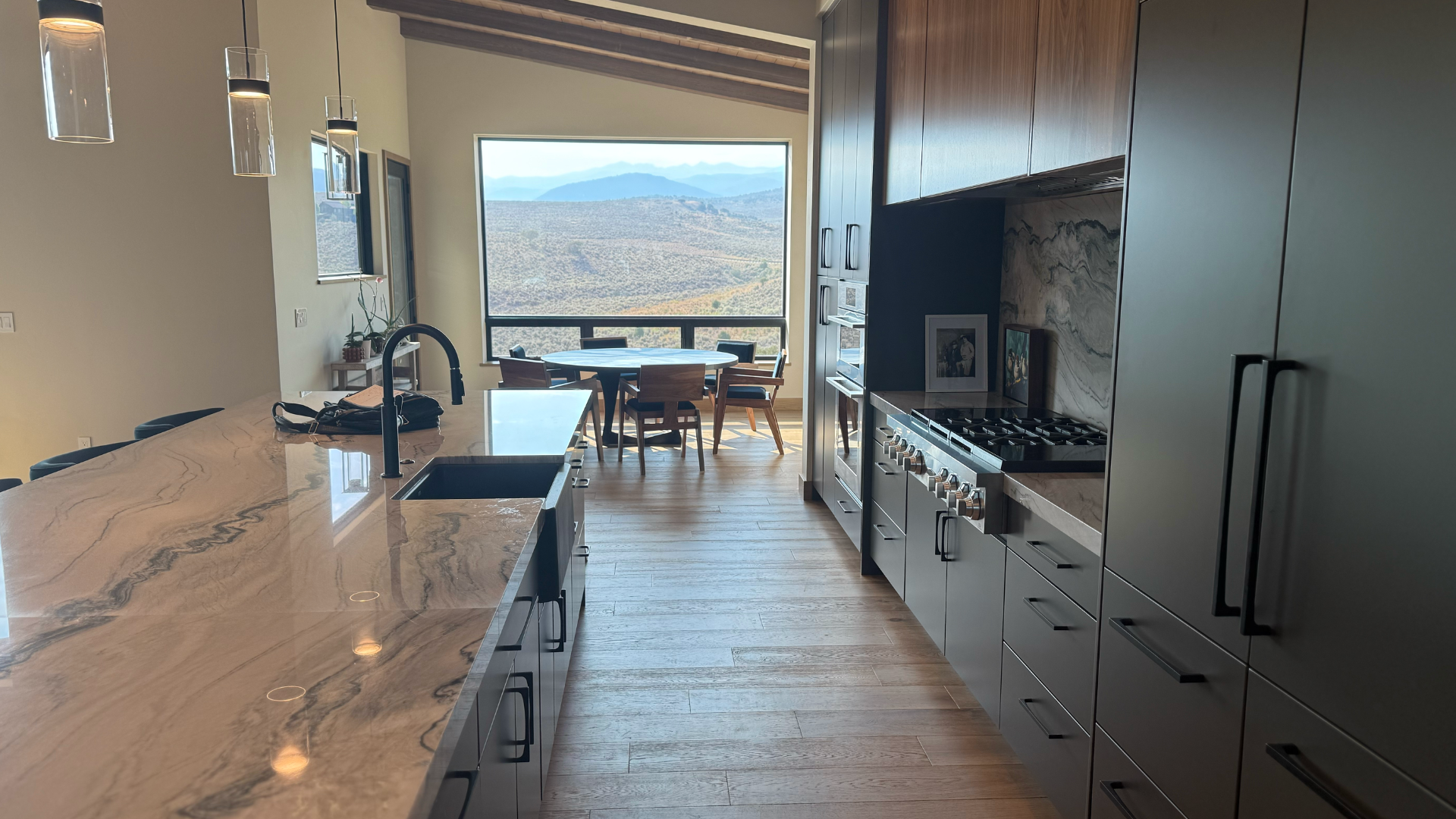 Luxury kitchen with custom cabinetry, natural hardwood flooring, and premium finishes