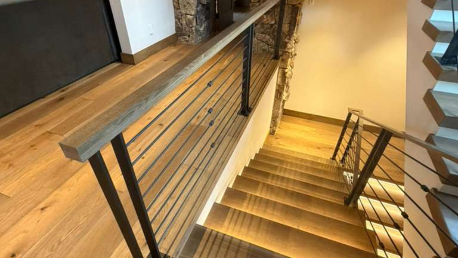 Custom hardwood staircase with modern railing in a Vail Valley luxury home